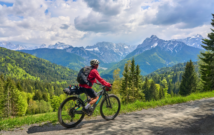 Seniorin auf einer E-Mountainbike-Tour am Vršič-Pass im Triglav-Nationalpark in den Julischen Alpen oberhalb von Kranska Gora in Slowenien
