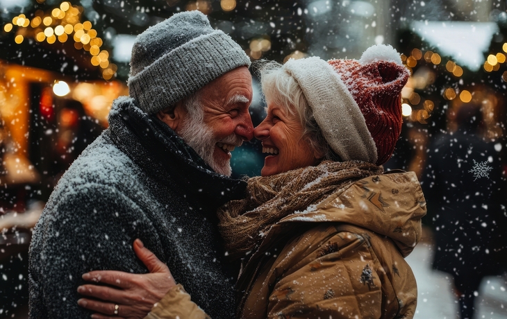 Älteres Paar hat Spaß auf einem Weihnachtsmarkt