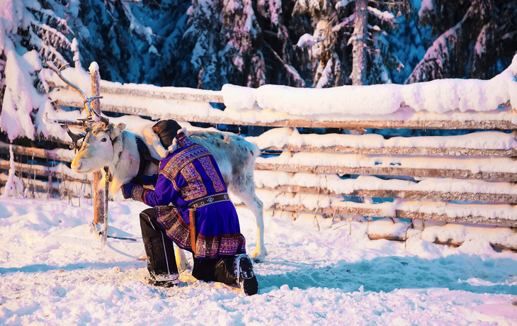 Mann im traditionellen Kleid des Saami am Ren Rovaniemi in Lappland, Finnland
