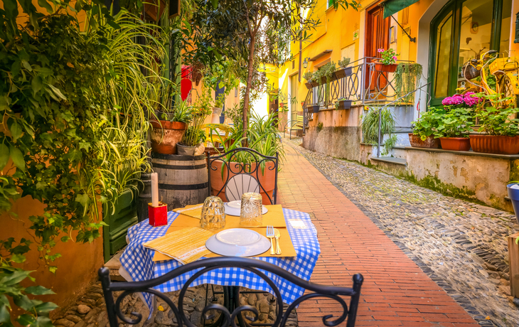 Table in a street of the old town of Bordighera, Italy
